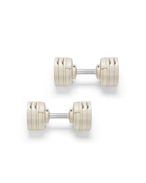 Close-up of NÜOBELL S 224 Sand adjustable dumbbell with sleek sand-colored finish designed for space-saving versatile strength training in any home gym