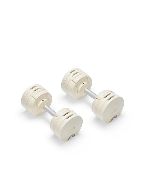 Close-up of NÜOBELL S 224 Sand adjustable dumbbell with sleek sand-colored finish designed for space-saving versatile strength training in any home gym
