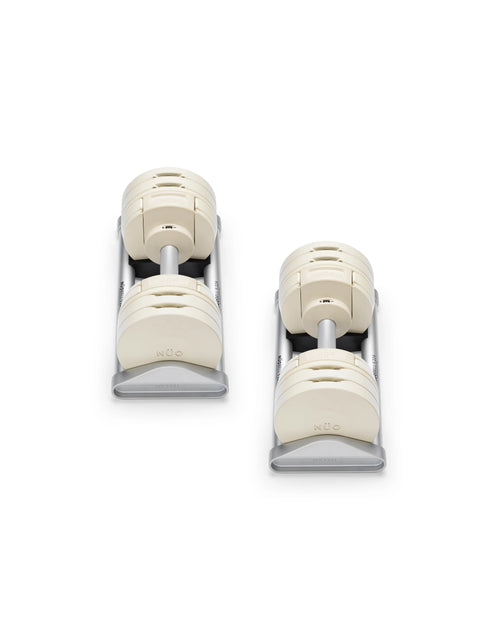 Close-up of NÜOBELL S 224 Sand adjustable dumbbell with sleek sand-colored finish designed for space-saving versatile strength training in any home gym