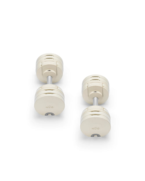 Close-up of NÜOBELL S 224 Sand adjustable dumbbell with sleek sand-colored finish designed for space-saving versatile strength training in any home gym